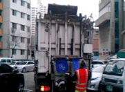 음식물 쓰레기 수거 사진 3 : 비워진 음식물 쓰레기 통이 부착된 기계에서 내려오는 사진